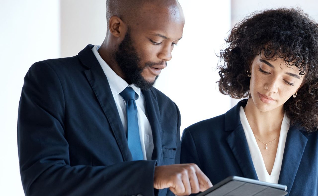 Two colleagues looking at tablet